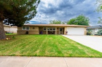 a house with a lawn and a garage